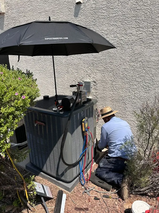 HVAC technician performing outdoor AC maintenance in Avon Park